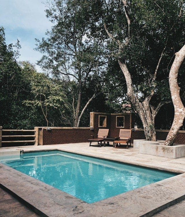 Two lounge chairs near swimming pool